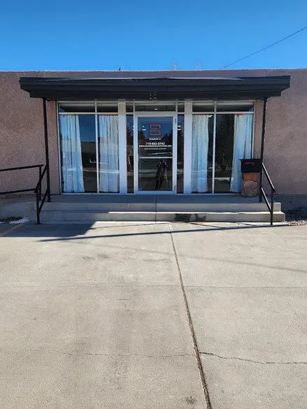 A building with steps leading to the front door.