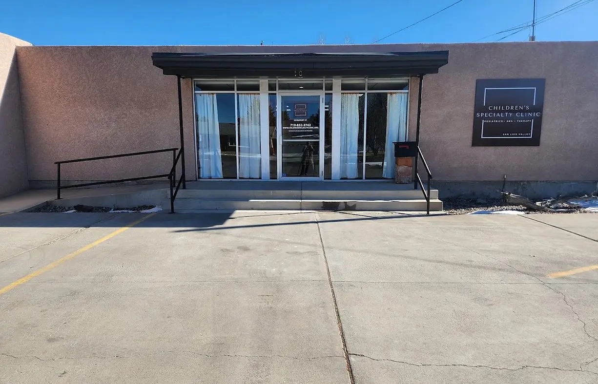 A building with two doors and steps leading to the front.